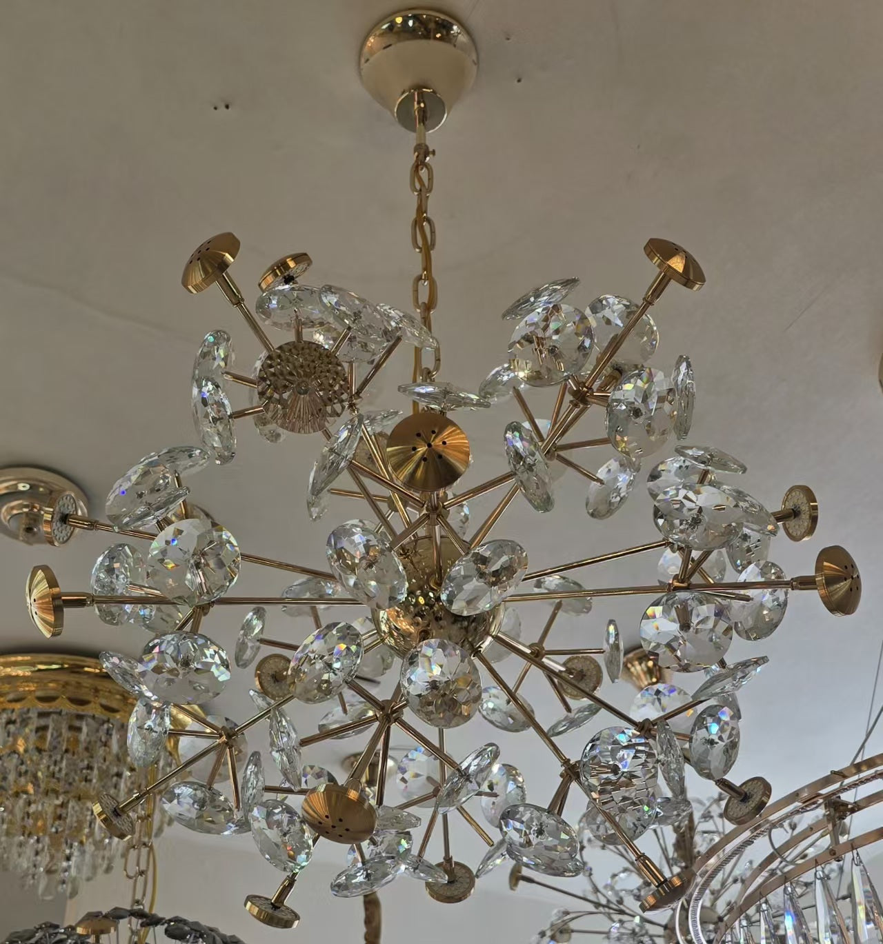 Gold and crystal chandelier hanging from a ceiling