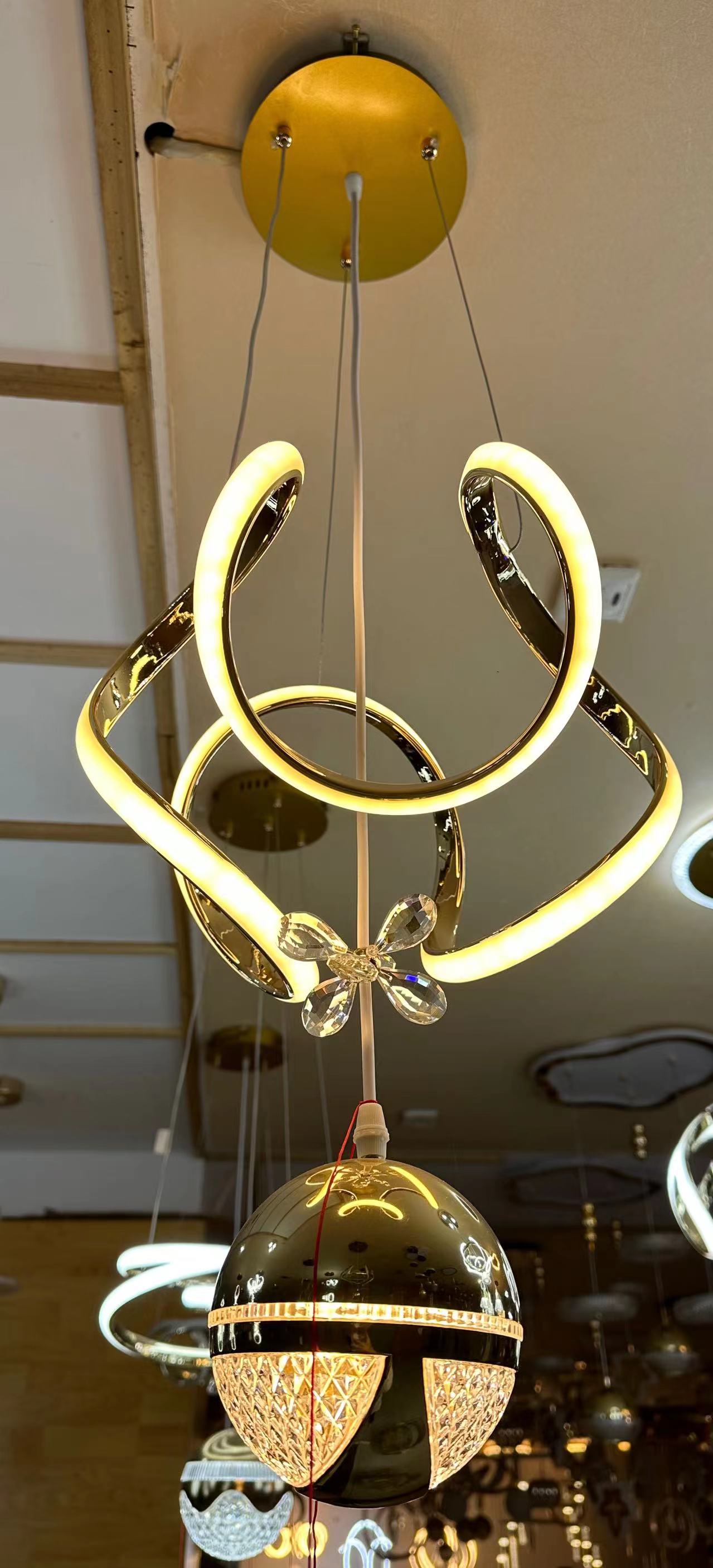 Modern chandelier with gold accents hanging from the ceiling.