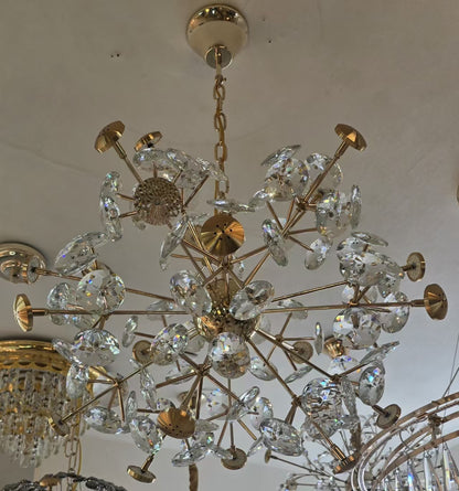 Gold and crystal chandelier hanging from a ceiling