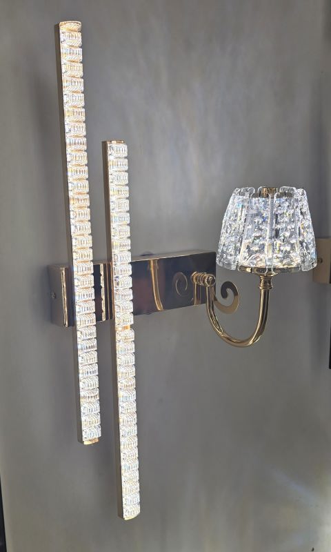 Decorative wall sconce with crystal accents on a gray wall